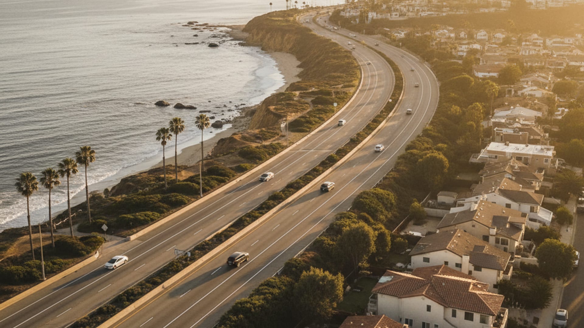 Aerial view of San Diego County freeway network at golden hour showing coastal Oceanside through inland Escondido to east-county Julian